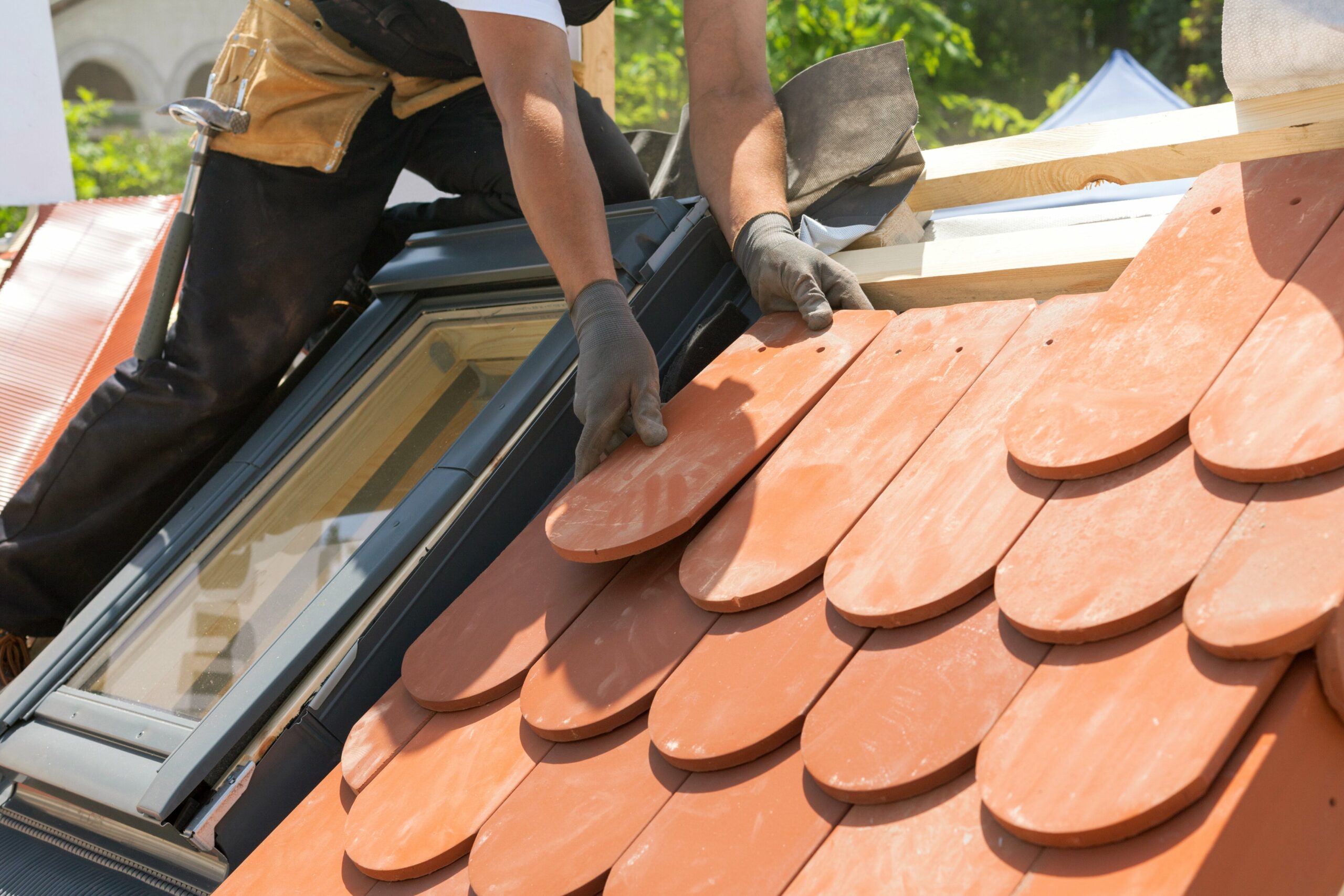 roofer putting on new roof tiles